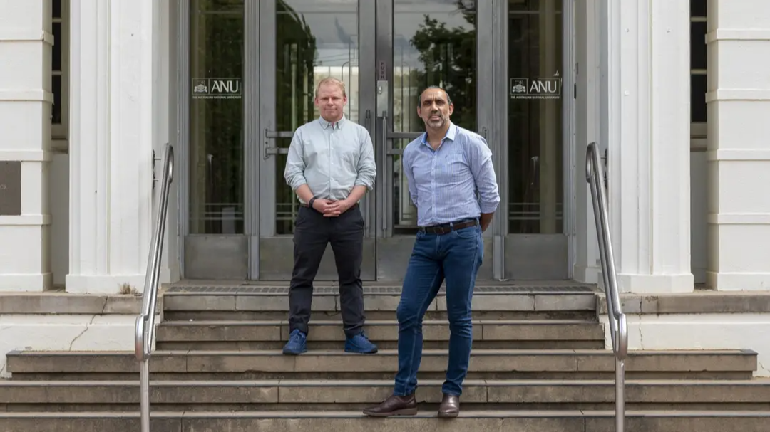 Adam Goodes and Baden Pailthorpe standing on the steps outside the ANU School of Art and Design.