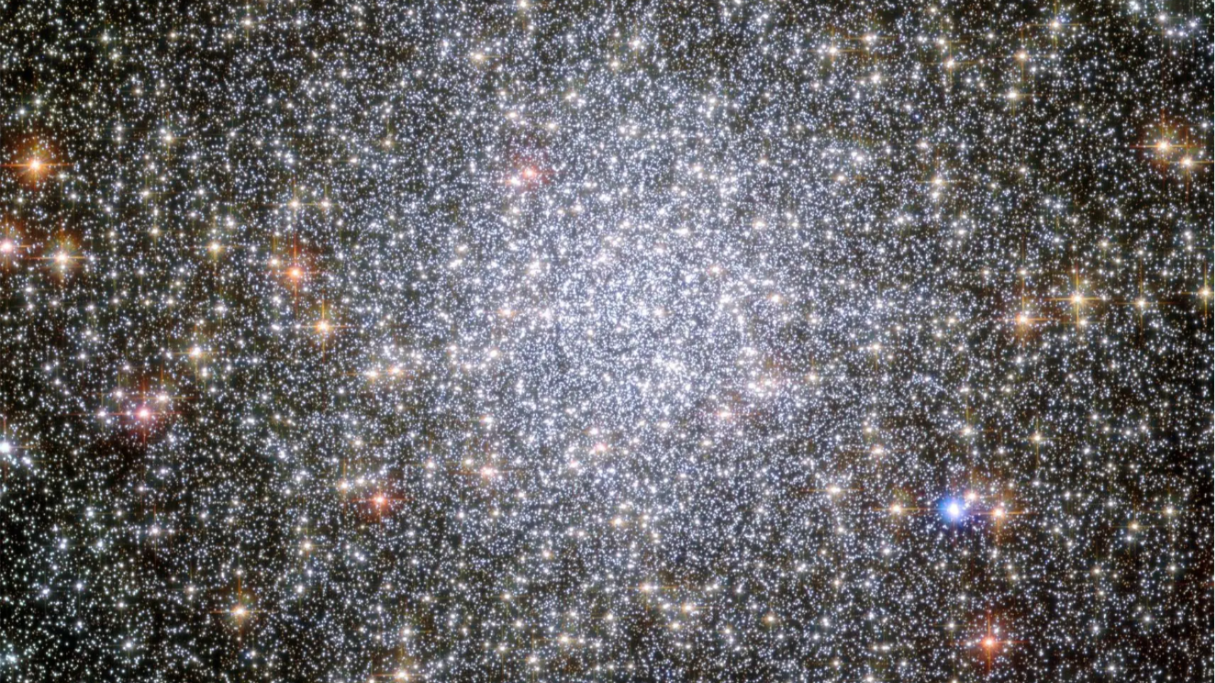 A cluster of stars, glowing brightly in the centre of the image