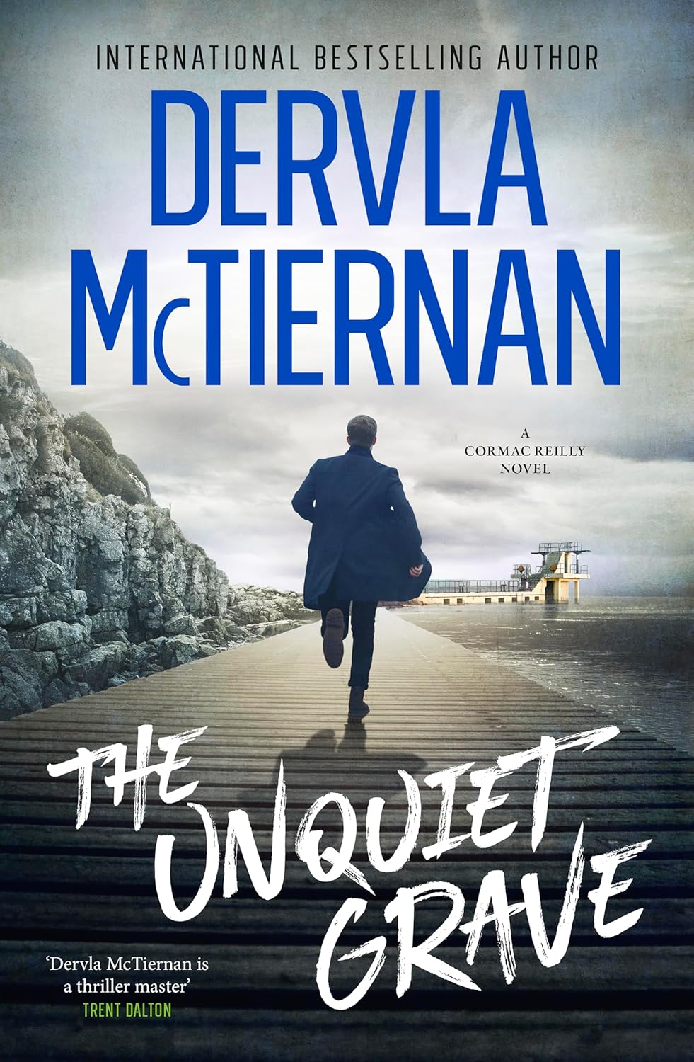 Register to hear author Dervla McTiernan discuss her book &ldquo;The Unquiet Grave&rdquo;. Book cover pictured, showing a man running along a pier toward a small structure over the water beneath a cloudy sky.