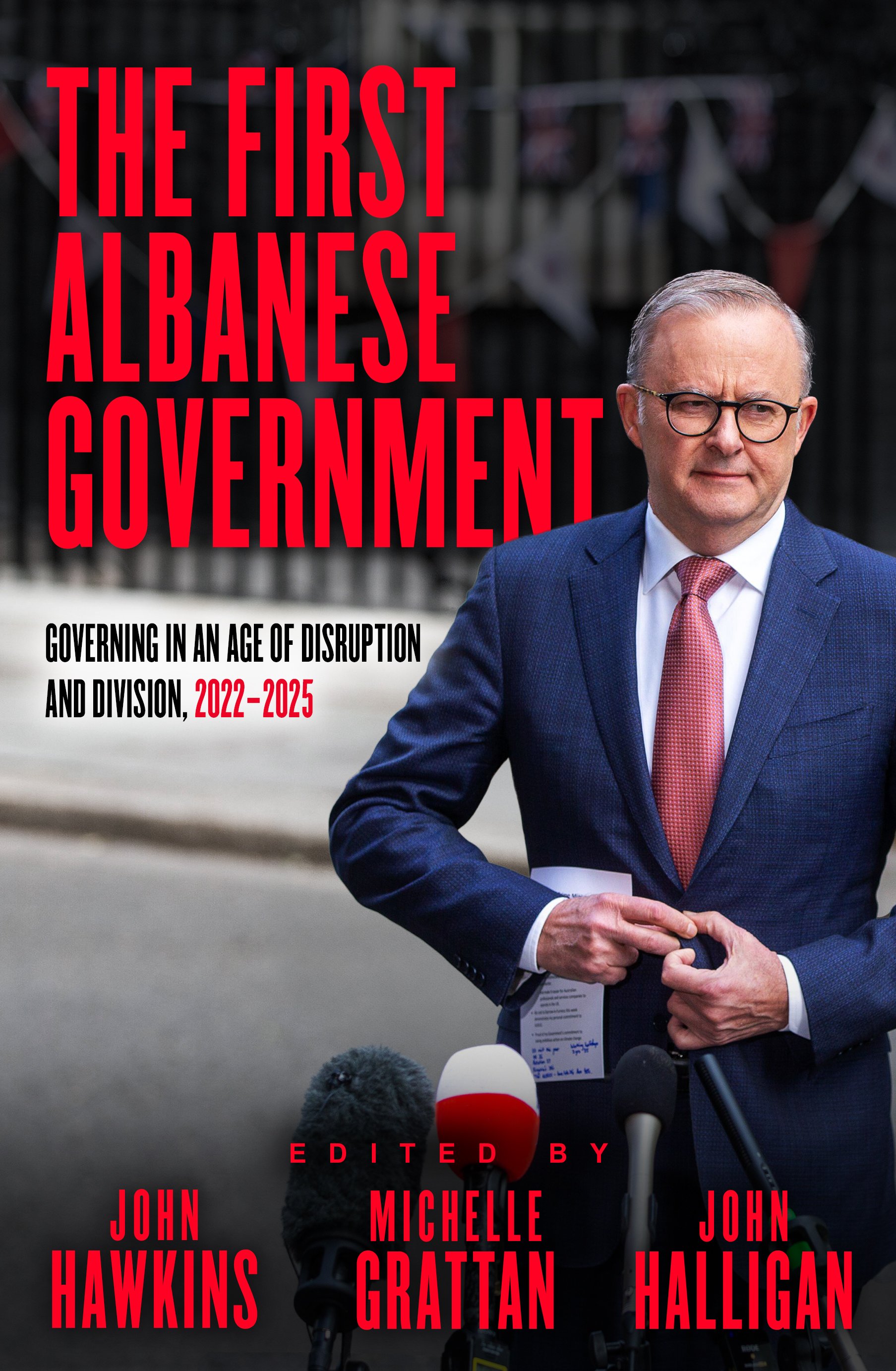 Book cover of The First Albanese Government, featuring Prime Minister Anthony Albanese standing at microphones outside Parliament, with bold red title text on a dark background.