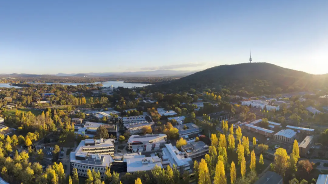 Aerial view of the ANU campus and surrounding Canberra landscape, with Black Mountain and Telstra Tower in the background.