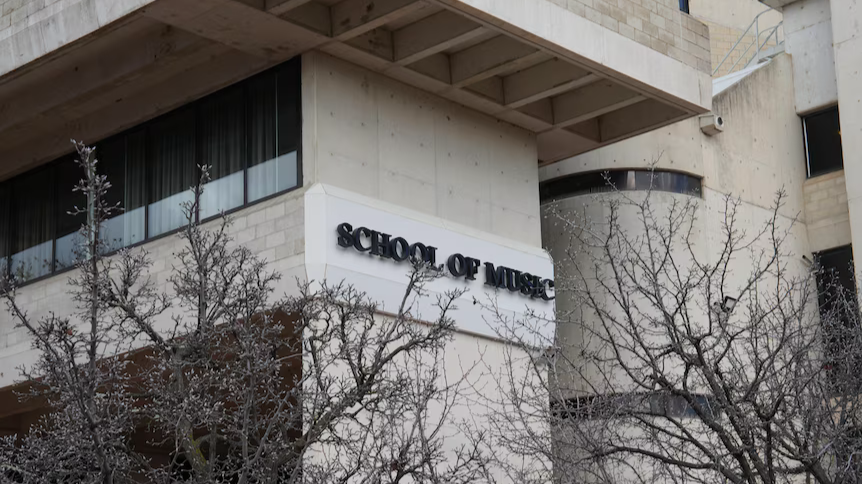 The exterior of the ������ƵSchool of Music shadowed by trees during fall. 