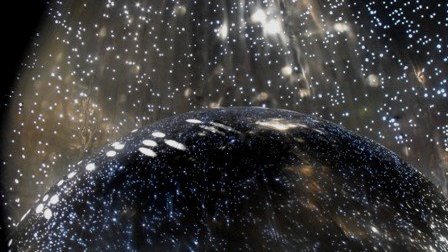 Inside art installation titled “UNA – A Pocket Universe,” showing a glowing dark sphere surrounded by shimmering lights like stars.