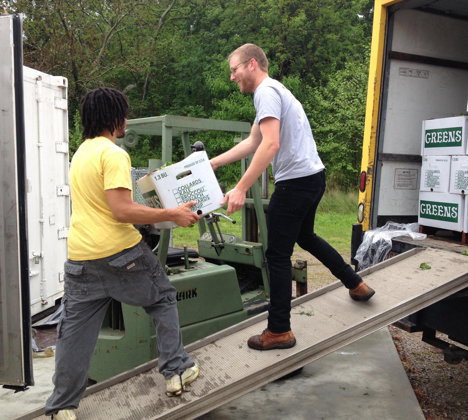 Photo of Working Landscapes staff unloading produce.