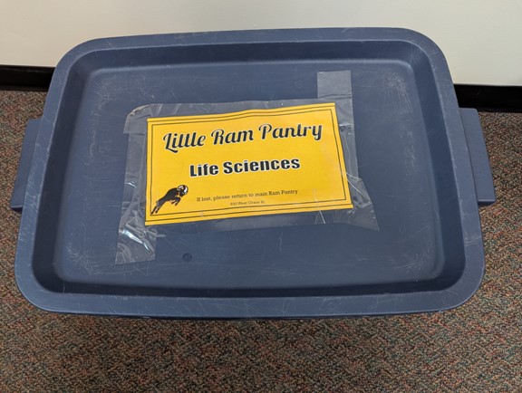 Figure 1 from the article: An entire month of food was distributed to a partner (in this case, the Life Sciences Department) around the first day of the month, generally in a large plastic tote containing four bags, each with a week’s worth of food. Someone from the administrative group, usually a student worker under the supervision of a full-time staff member, would restock the pantry from the tote using one bag per week. Photo provided.