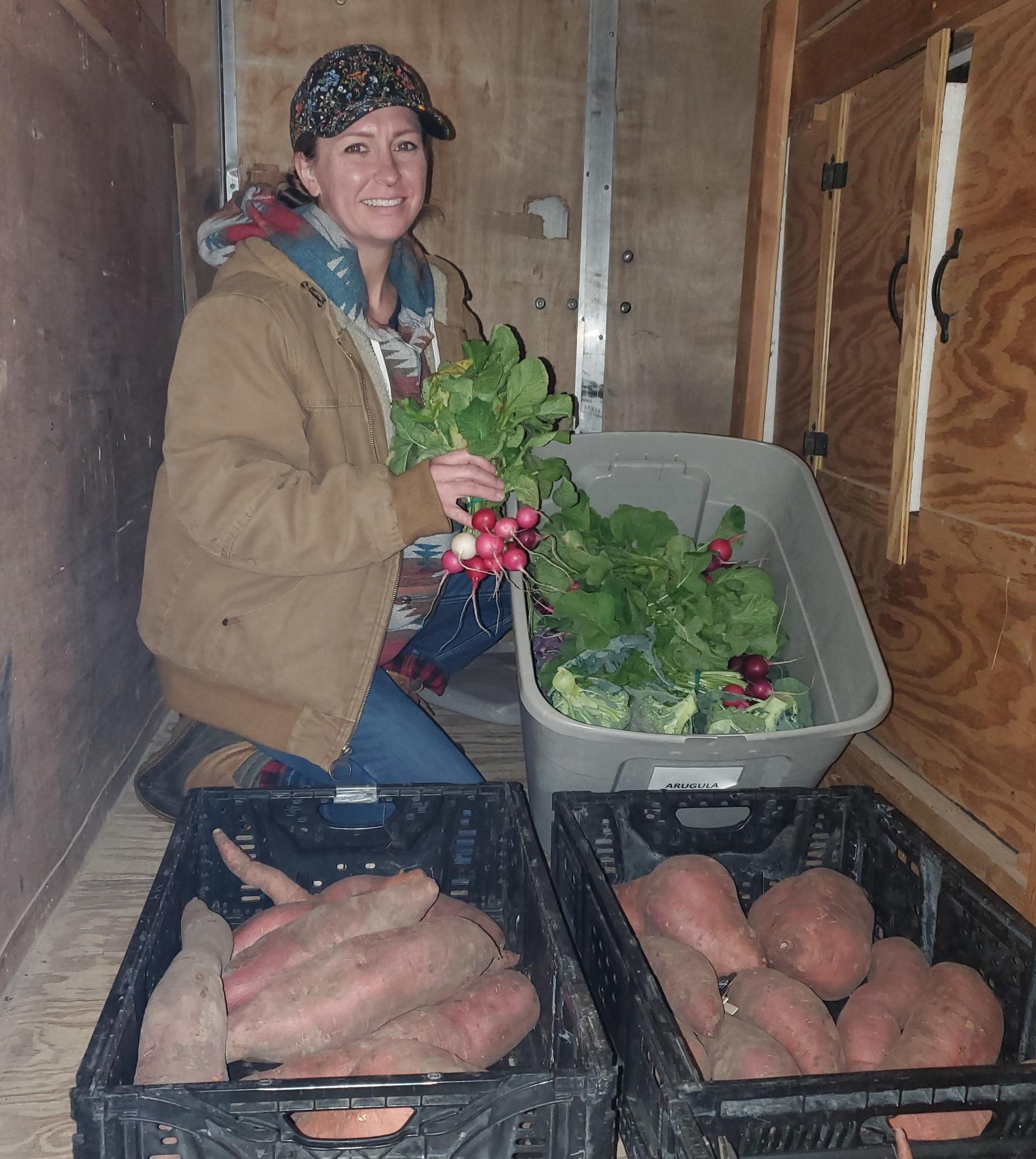 Becca Knutson, owner of Hollow Trace Farm in Azle, Texas, preparing to unload products for market from the farm’s custom trailer. Photo provided by Carolyn Krejci.