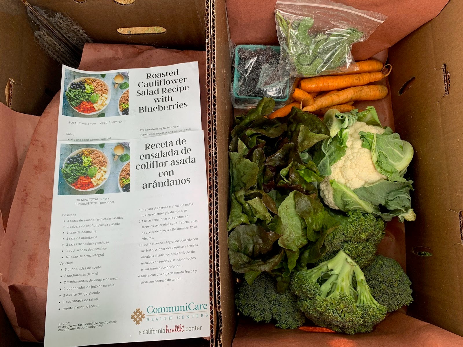 Photo of a box of produce and recipes: Produce prescriptions provide patients with elevated blood glucose access to locally grown produce accompanied by recipes (credit: Edye Kuyper).