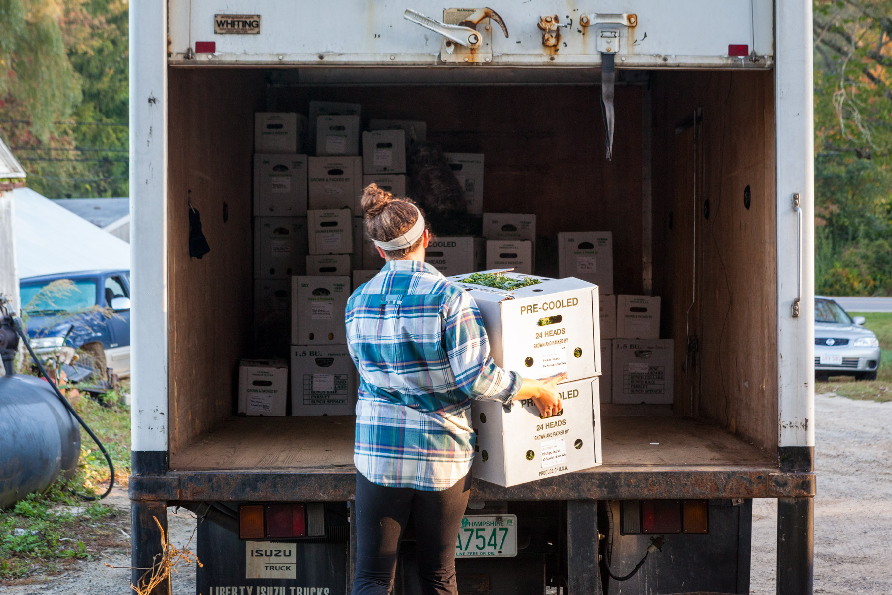 Photo: A woman loads a truck with fresh products at a warehouse facility in New Hampshire (USA) that aggregates, stores and distributes products from farmers across the region. Photo by John Benford and provided by the authors. 