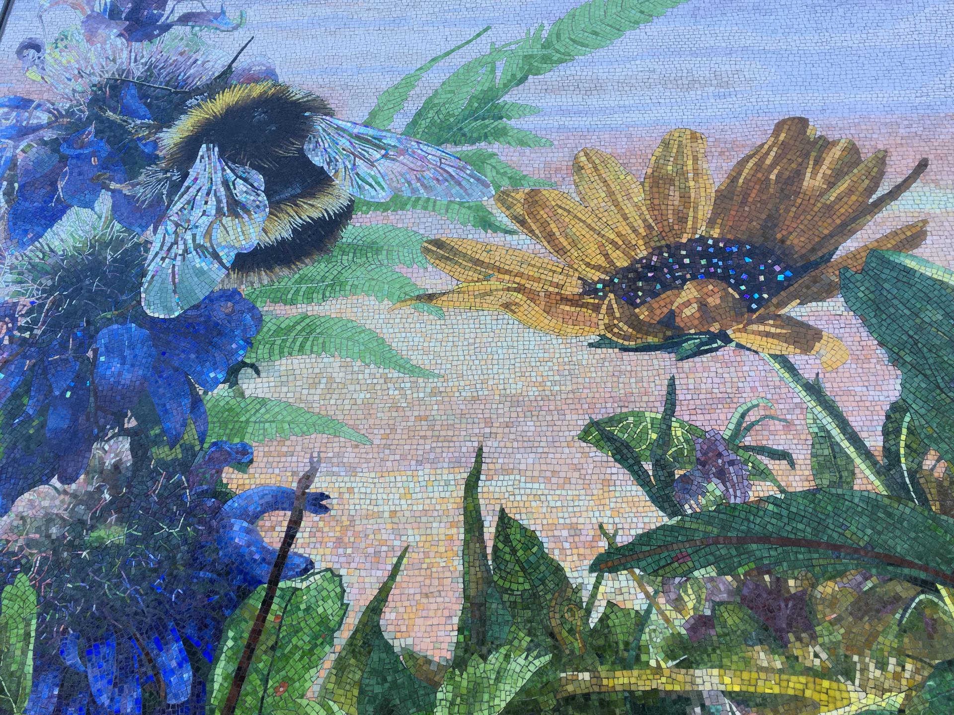 Photo of a mural in Houston, Texas, USA, with a flower and bee. Photo by Amy Christian.