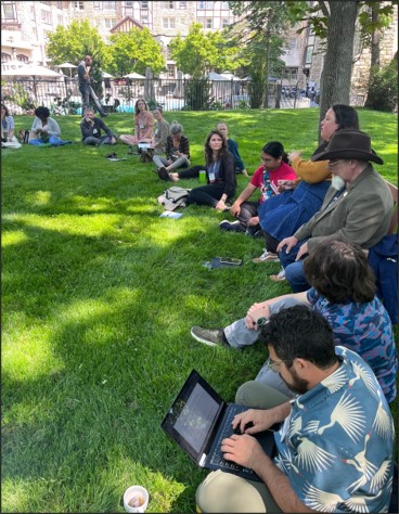 Participants at the U.S. Agroecology Summit 2023 sit in a circle outside (of the “Empire” conference room) to hold dialogue about moving Outside Empire altogether. Photo by author Antonio Roman-Alcalá, May 23, 2023.