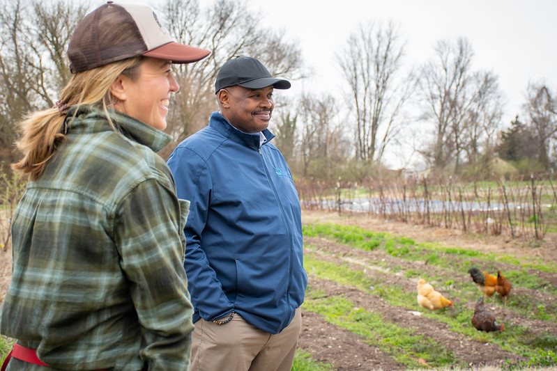 Photo: Natural Resource Conservation Service Chief Terry Cosby (at right) visited EarthDance Organic Farm in St. Louis, Missouri, and met with founder and CEO Molly Rockamann (at left) to discuss how Environmental Quality Incentives Program (EQIP) funds have aided her high-tunnel operation. USDA photo by Josh Colligan, 3/23/2023; public domain.