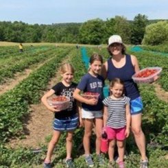 Photo of a mother and kids at a you-pick strawberry farm in Vermont.