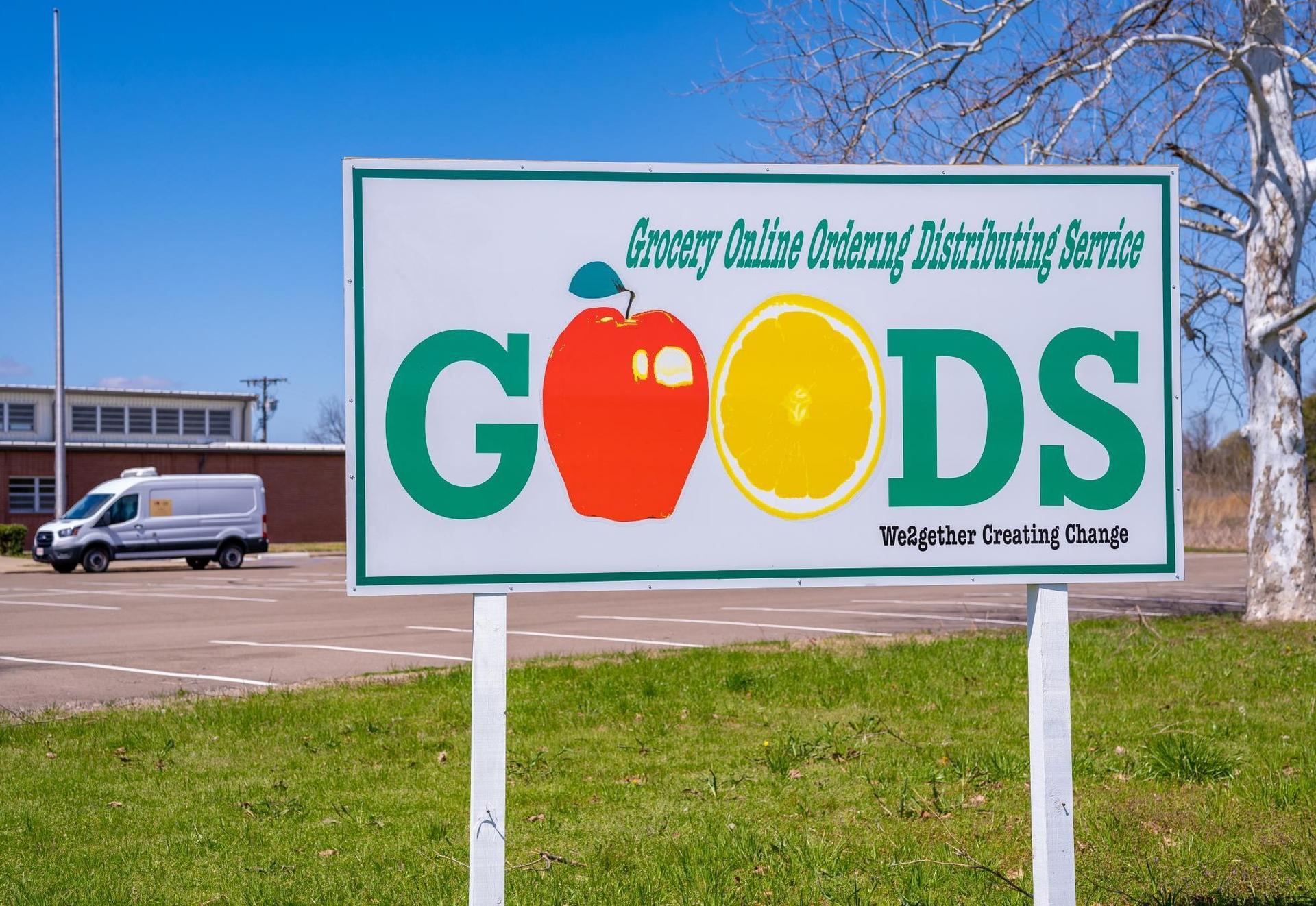 A sign promoting the online ordering system, GOODS. Photo provided by the authors.