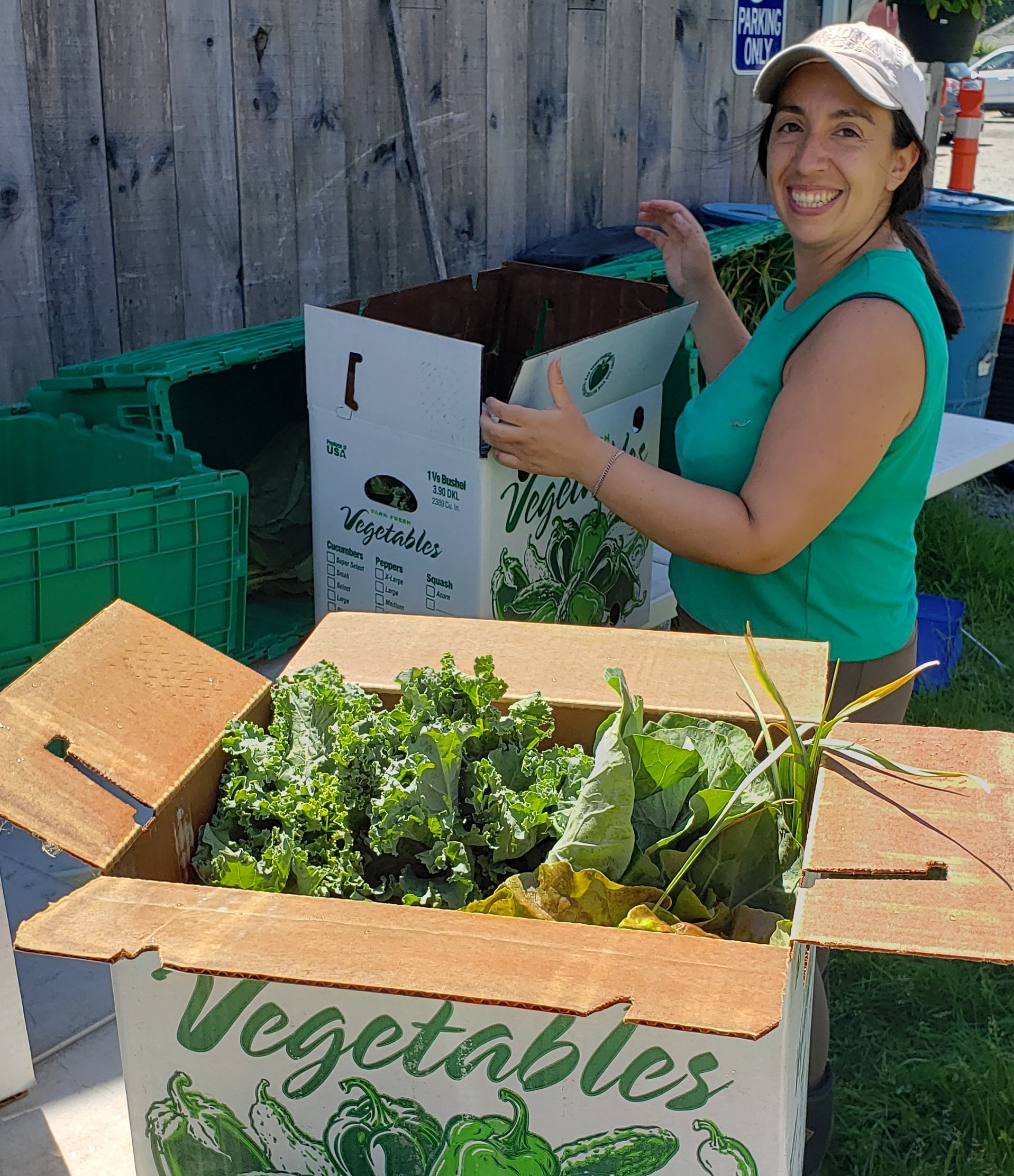 Waltham Fields Community Farm outreach farmer Marie-Ana packing boxes for the VegRx program. Photo provided by WFCF.