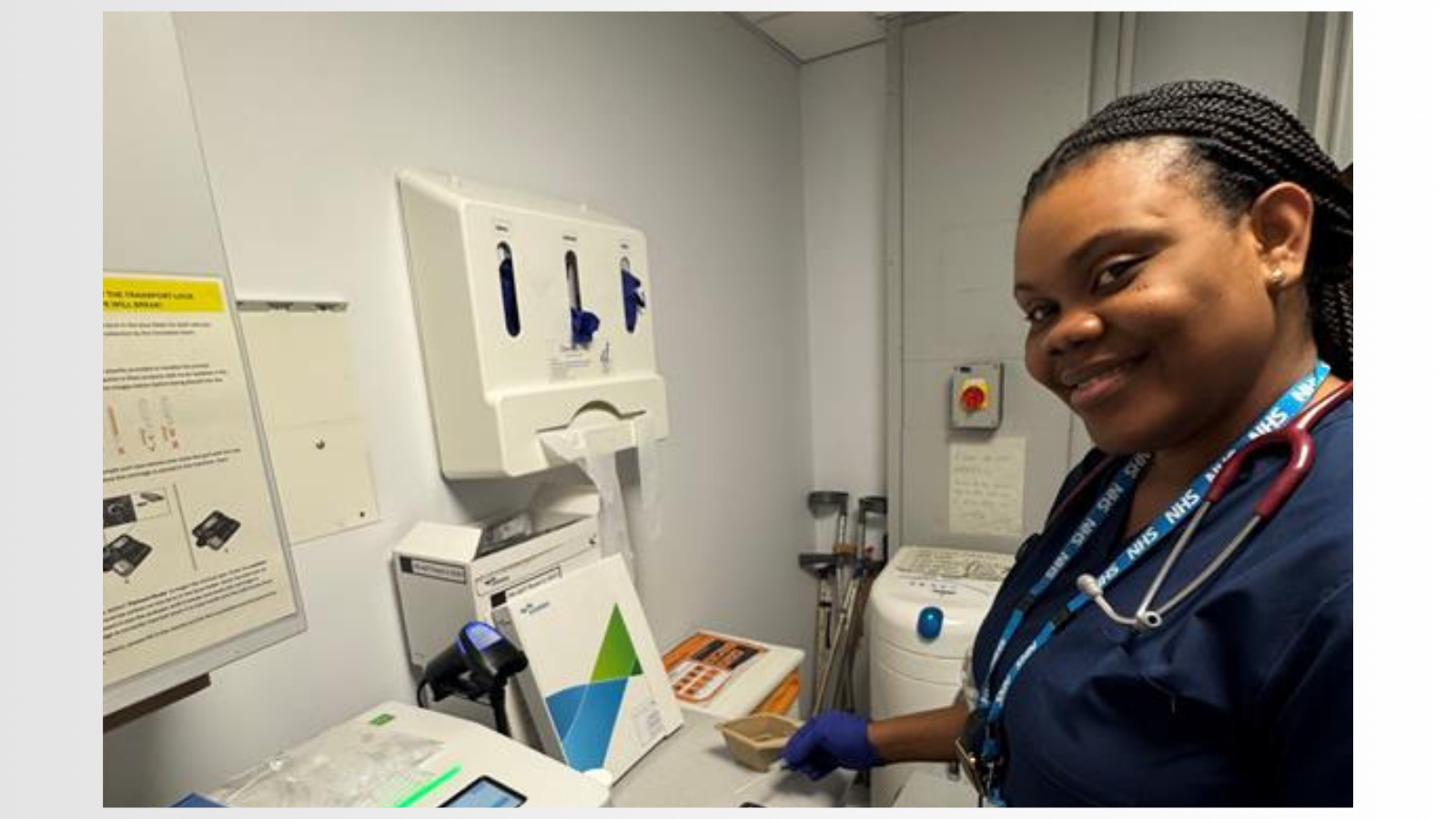 Woman smiling next to medical equipment