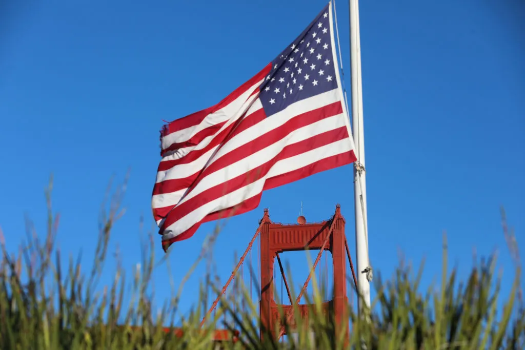 American flag with bridge in background