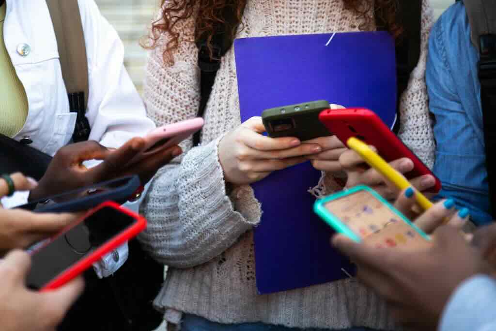 group of teenagers holding cell phones