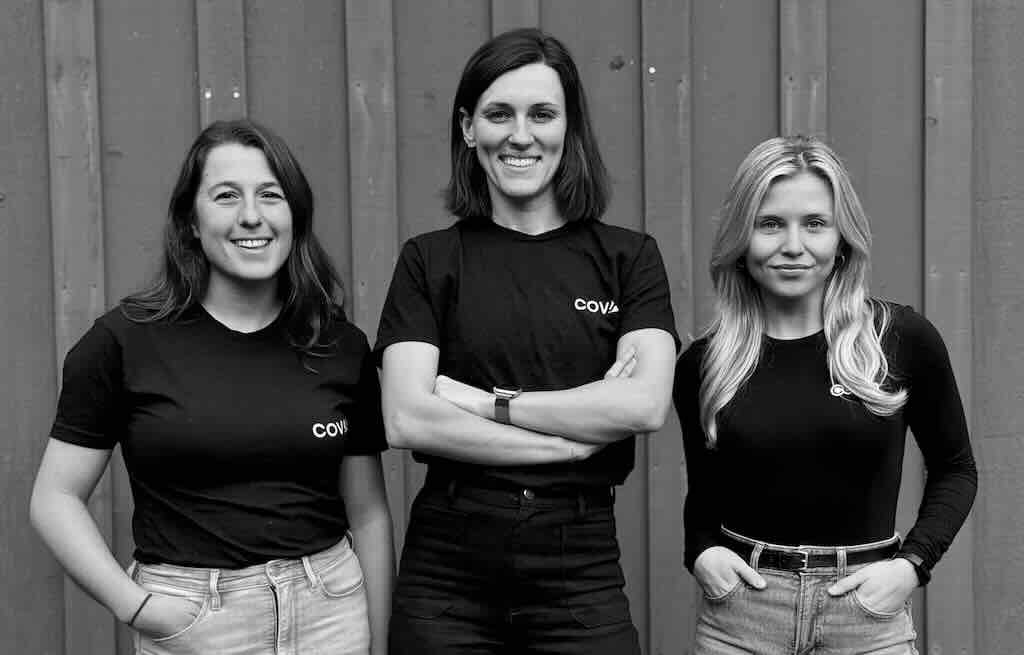 Three women wearing Coval shirts