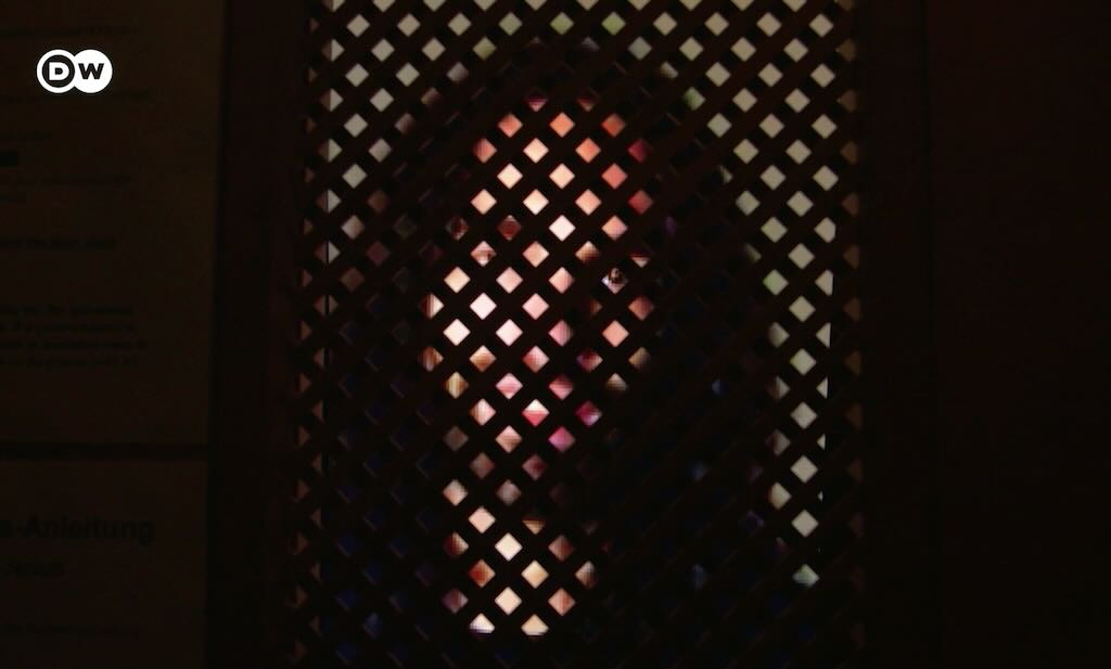 woman behind a confessional screen