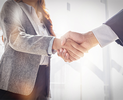 Photo of two people shaking hands.