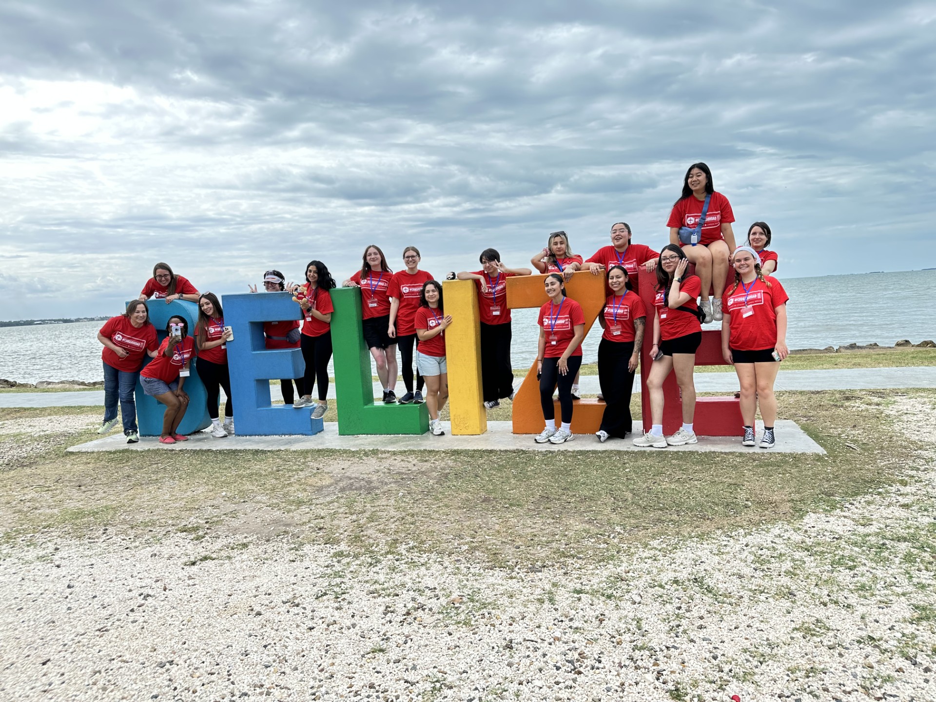 COMG Coogs posing in front of BELIZE sign