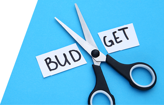 Stock photo of scissors and a paper tab that says Budget