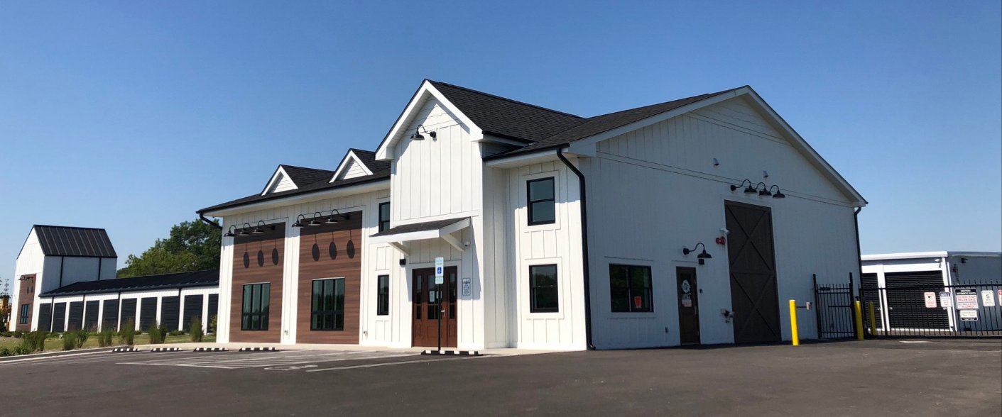 a woman and a boy sitting at a table with colored pencils