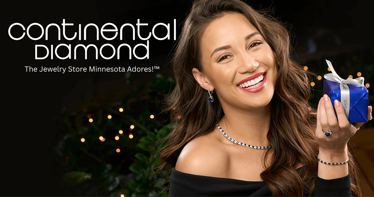 Continental Diamond | The Jewelry Store Minnesota Adores!™ | Smiling woman wearing jewelry and holding a small wrapped present