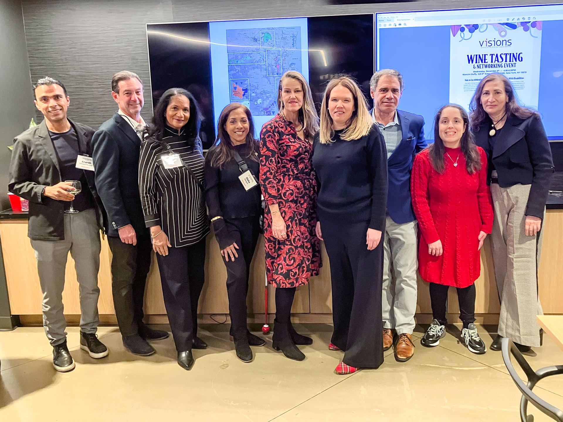 Photo of a group of Manhattan Advisory Board members standing together, smiling to the camera.
