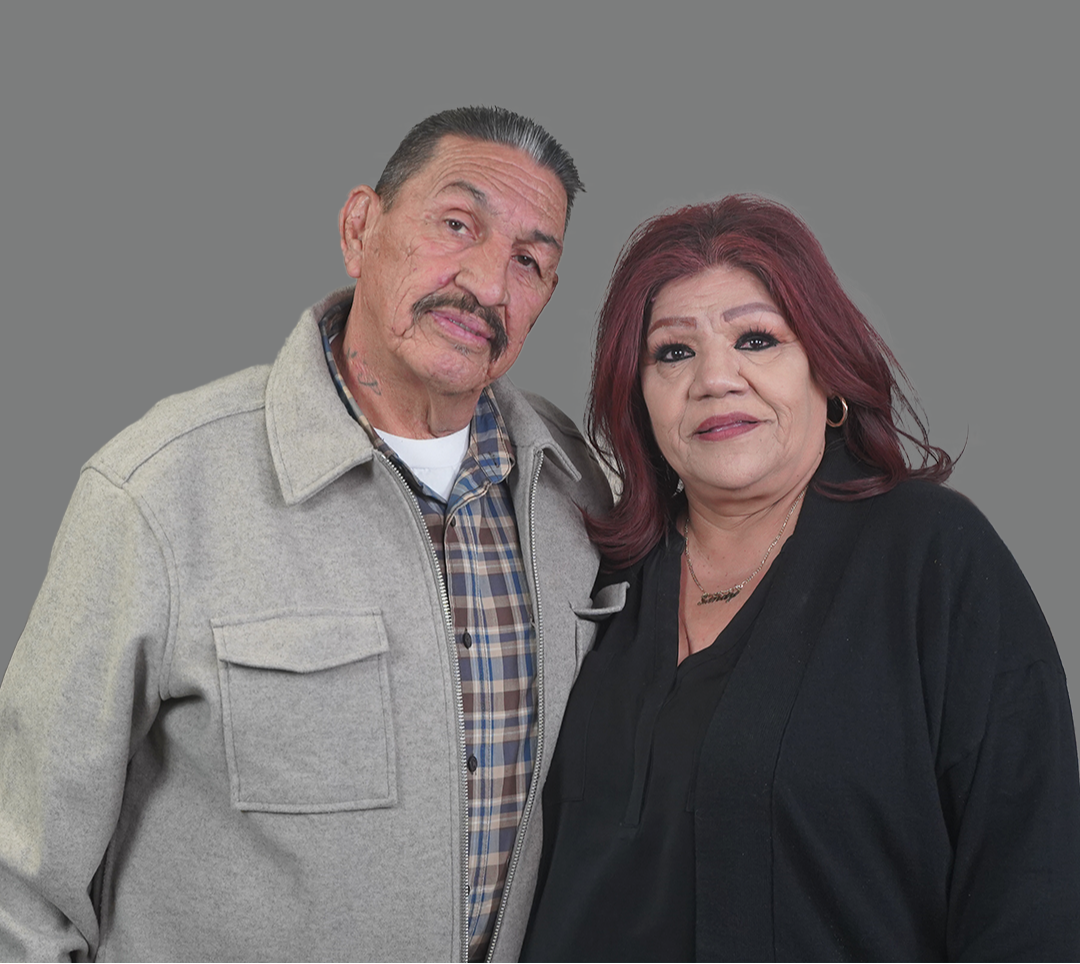 a family sitting on a dock with blanket on