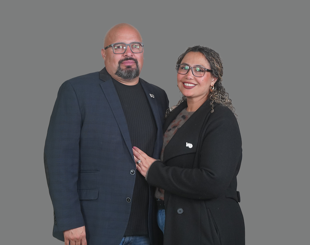 a family sitting on a dock with blanket on