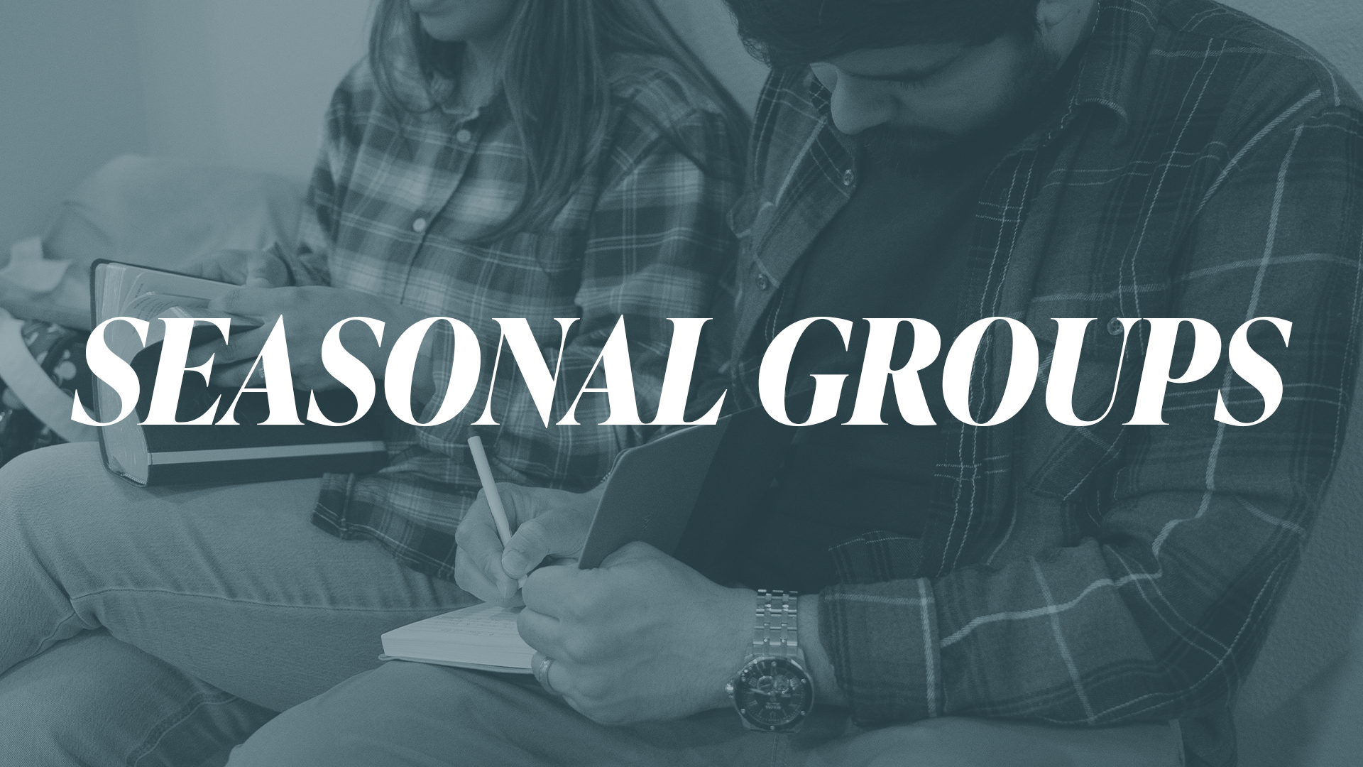 a family sitting on a dock with blanket on