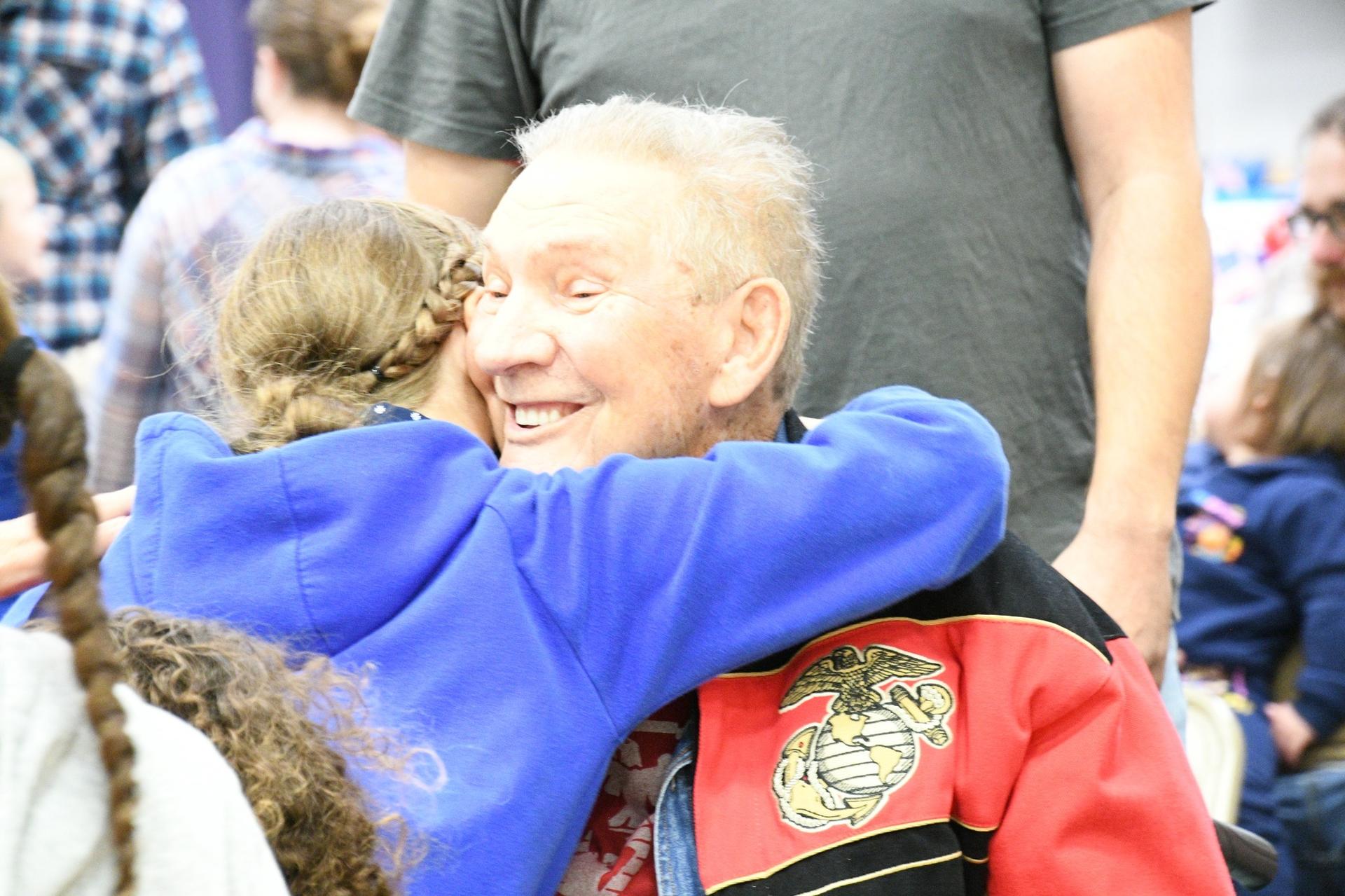 Picture of Veterans Day School Celebrations - Student hugging veteran