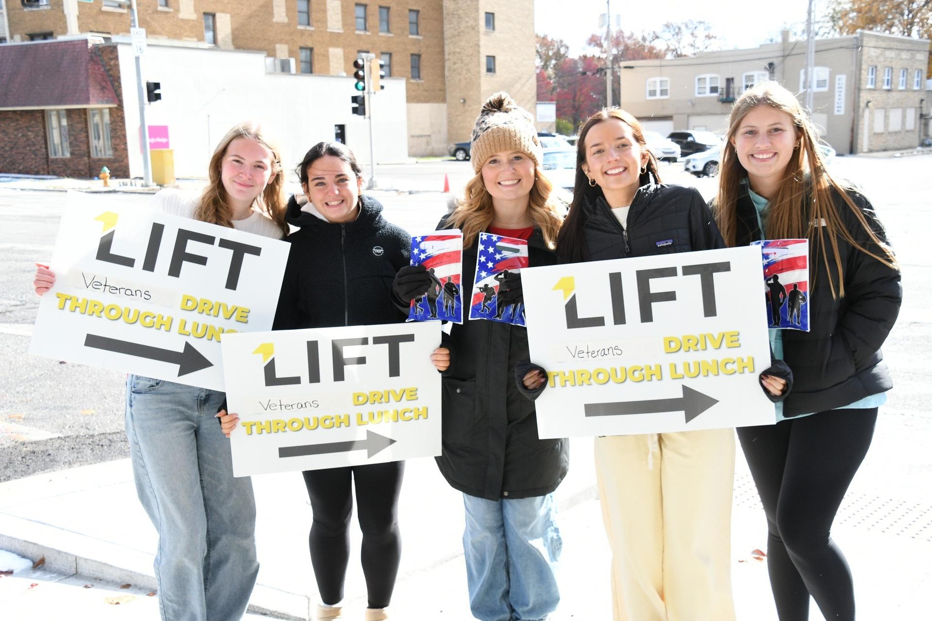 Picture of Veterans Day School Celebrations - LIFT handing out food