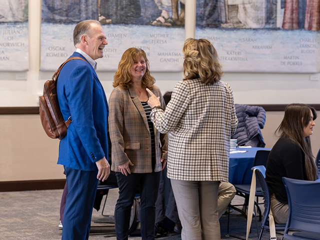 President Harris mingles during an event. 