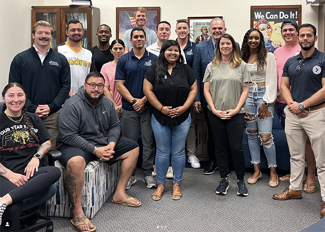 USD President James T. Harris III, DEd, poses with students in the Military & Veterans Program.
