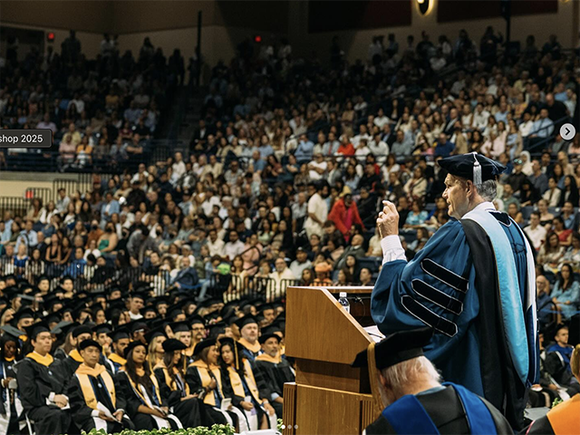 Dr. Harris speaks to graduates during a commencement ceremony in the Jenny Craig Pavilion.