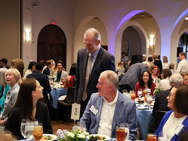 President Harris talks to students and benefactors during the annual scholarship luncheon.
