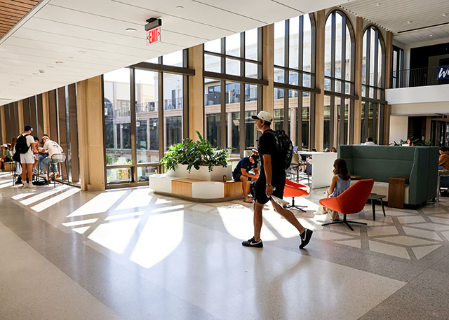 A student walks through the Knauss Center for Business Education