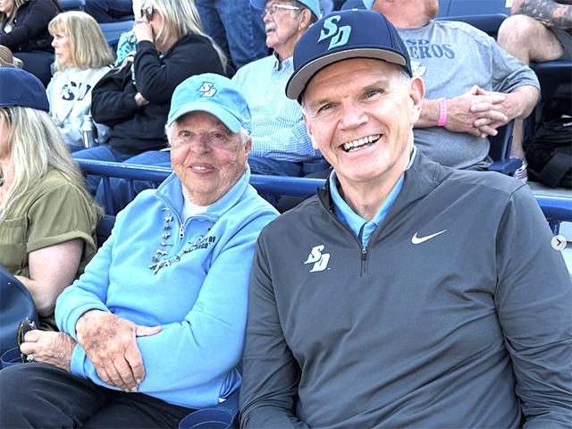 President Harris and Reggie Smith during the opening game of the 2025 USD Softball season.