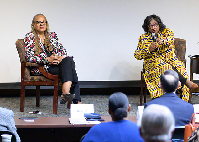 Regina Dixon Reeves and Renetta Garrison Hull speak to attendees of the Distinguished Lecture Series