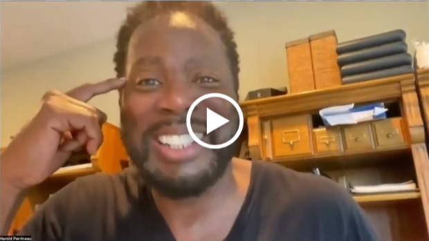 a man smiling with a play button