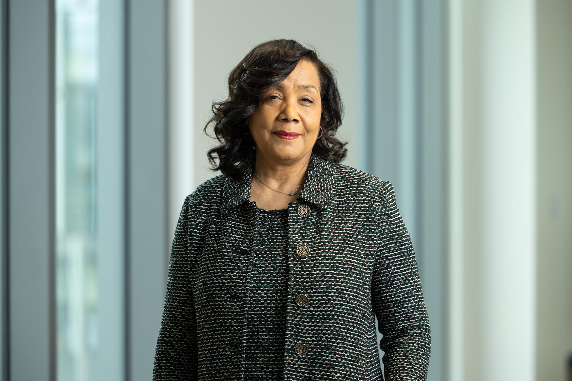 Photo of Dr. Bettina Beach standing in front of a window