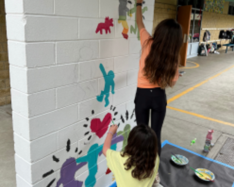 students working on the murals