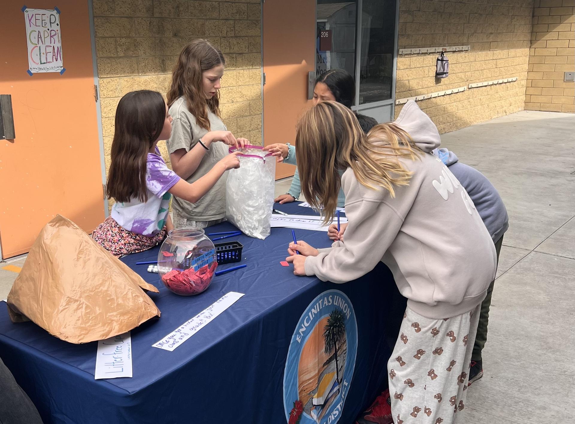 Green team students collecting litter around campus.