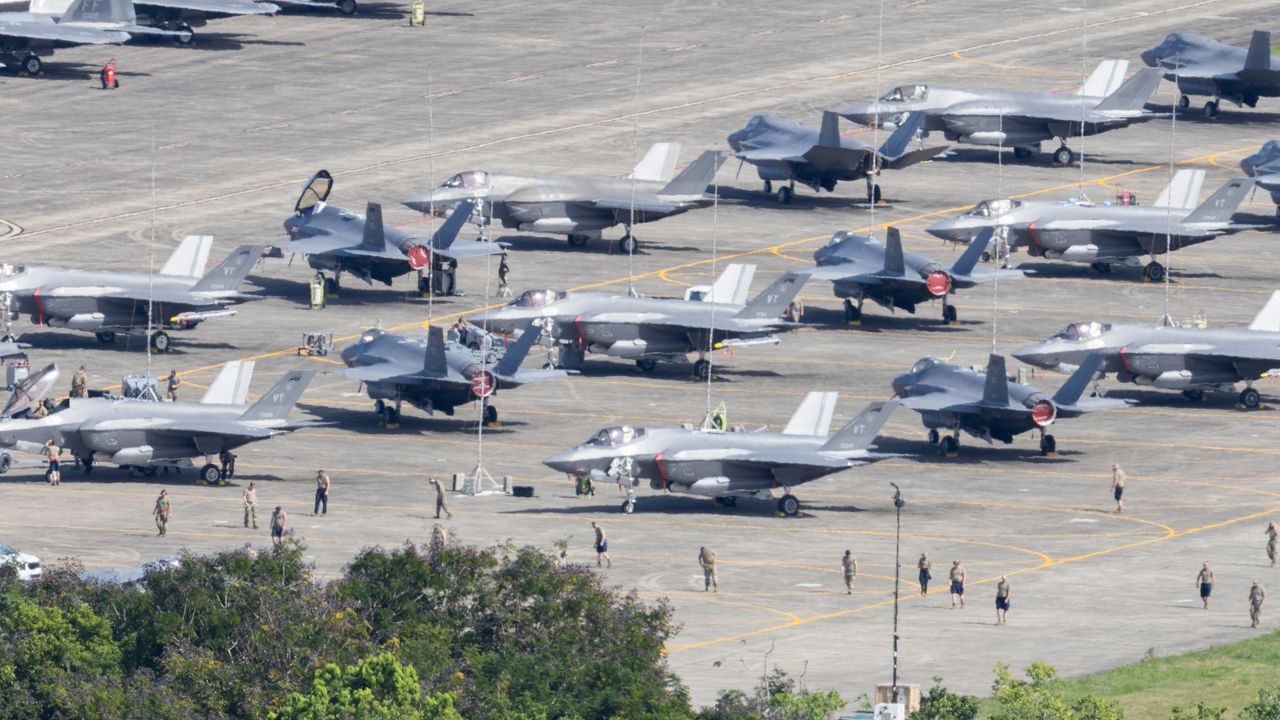 U.S. F-35 fighter jets are parked on the tarmac as military personnel walk among the aircraft at José Aponte de la Torre Airport in Ceiba, Puerto Rico, Saturday, Jan. 3, 2026. (AP Photo/Alejandro Granadillo)