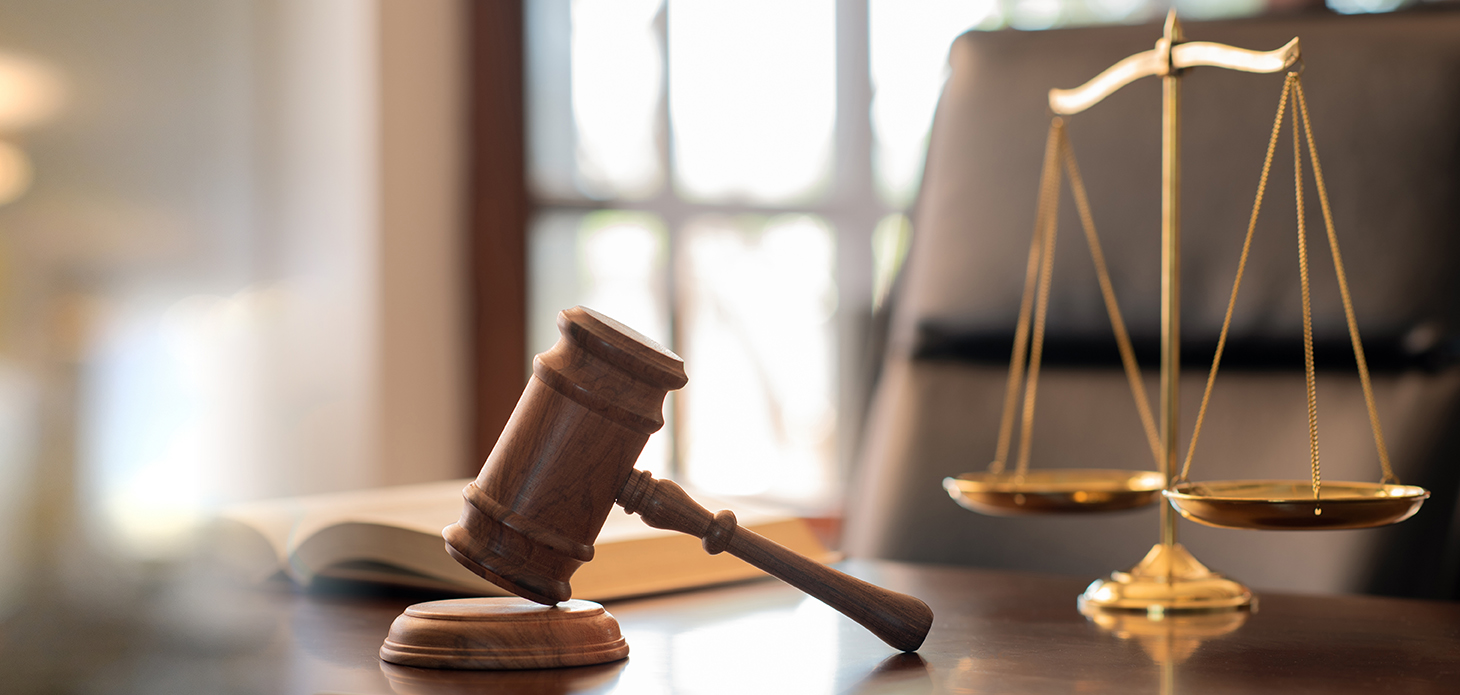 a gavel on a table with a scale
