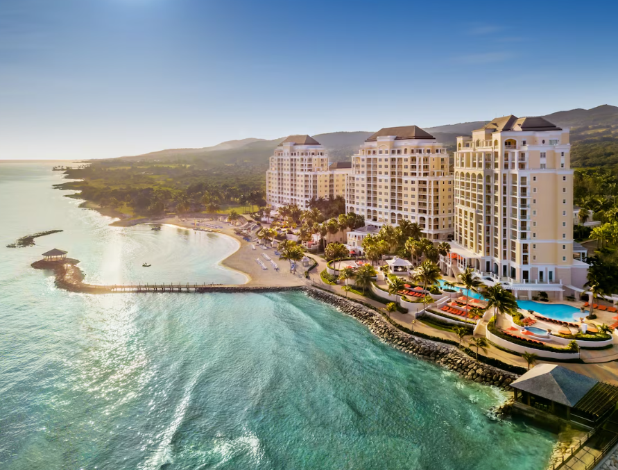 a woman sitting on a pool edge talking on a phone