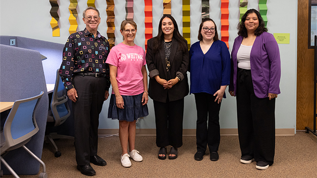 Five staff members stand together in the testing center.
