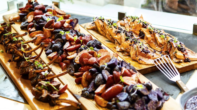 An attractive display of food arranged on wooden boards.